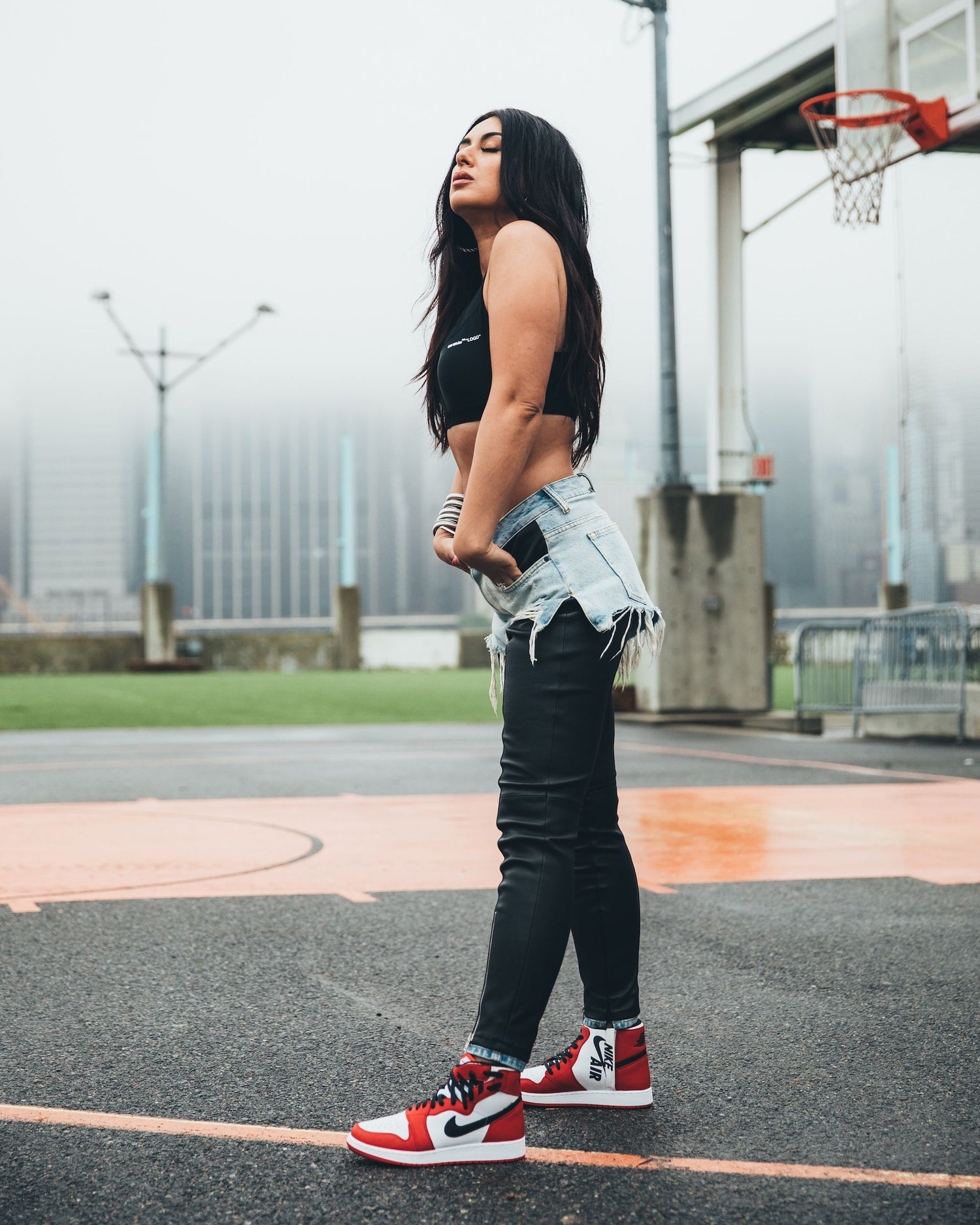 Girl on basketball court showing off her shoes.